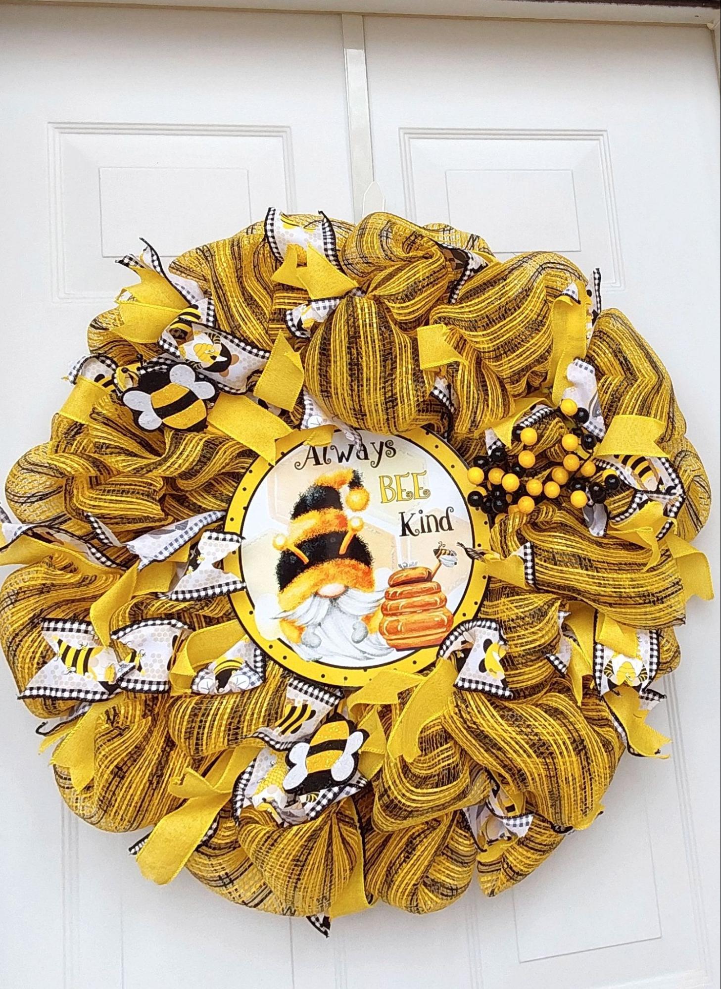 Black and yellow ribboned wreath wiht bee emblems on it.
