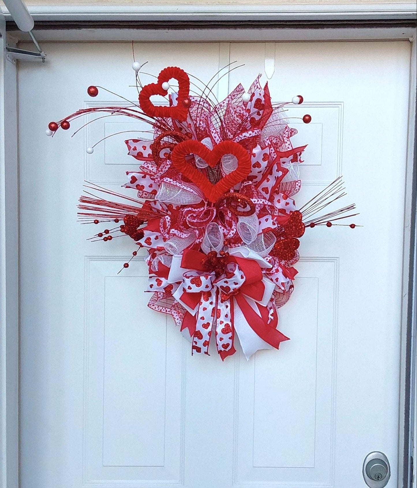 Teardrop wreath with Valentine's hearts, ribbons, and more.
