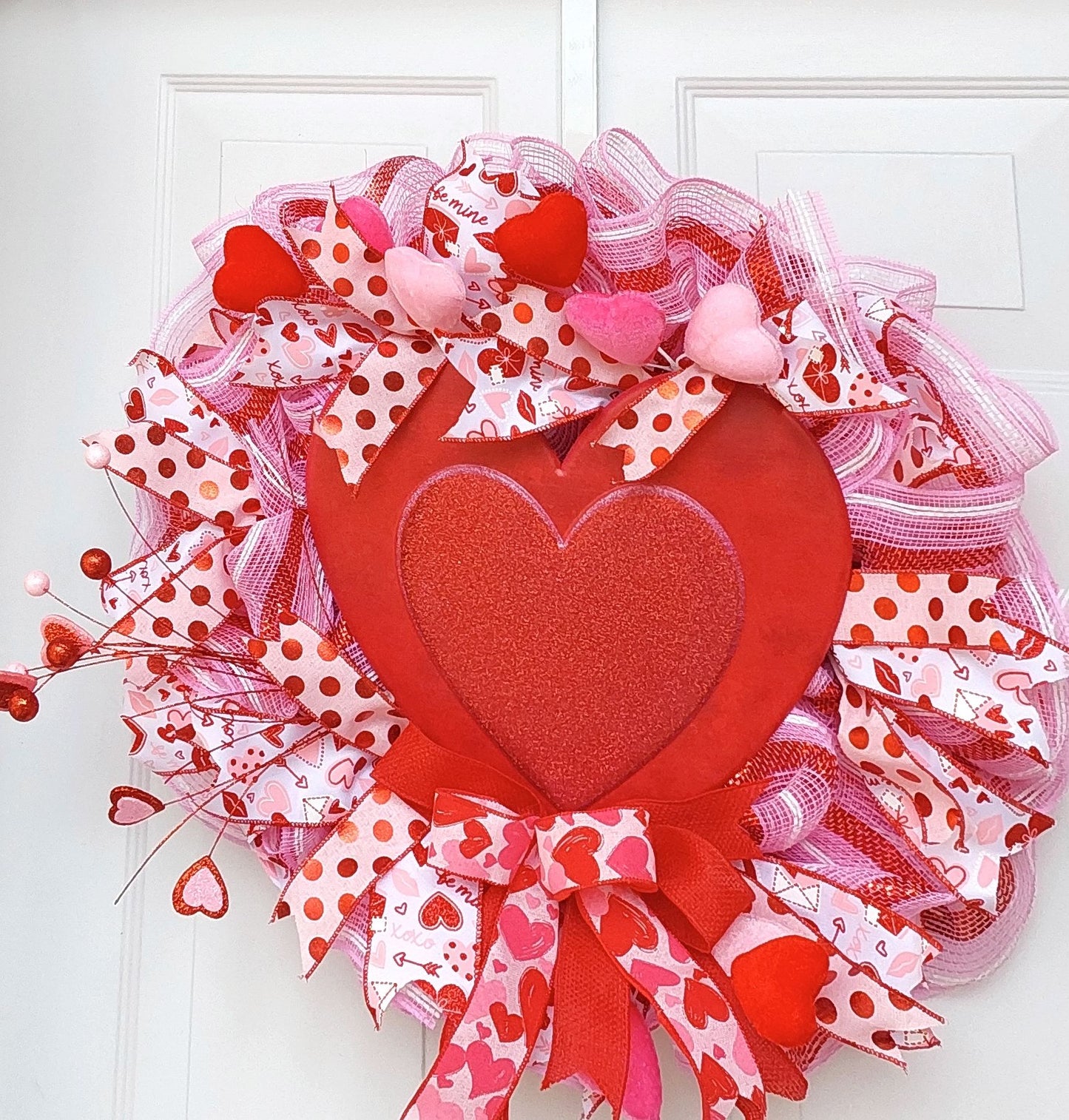 Valentine's wreath with a large, red heart centerpiece